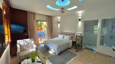 a bedroom with a bed and a glass shower at Luxurious Villa with private pool, Jacuzzi & Cuisinière in Marrakech