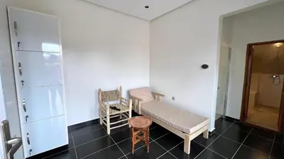 a room with a bench and a chair in it at Luxurious Villa with private pool, Jacuzzi & Cuisinière in Marrakech