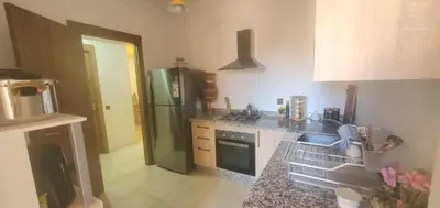 a kitchen with a green refrigerator and a sink at appartement cosy plein centre in Marrakech
