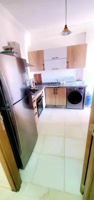a kitchen with a stainless steel refrigerator and cabinets at appartement cosy plein centre in Marrakech