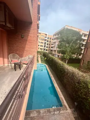 a small swimming pool next to a building at Appartement piscine in Marrakech