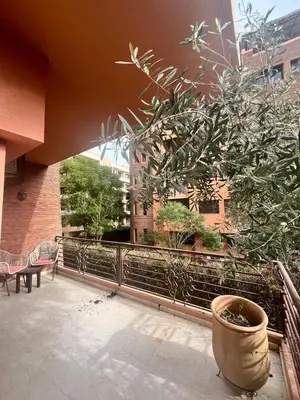 a plant in a pot sitting on a patio at Appartement piscine in Marrakech