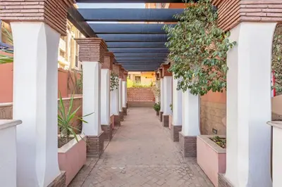 a hallway of a house with a blue ceiling at Appartement piscine in Marrakech