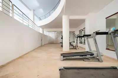 a gym with treadmills and a treadmill at C-Appartement de luxe plein centre de gueliz avec piscine parking wifi netflix in Marrakech