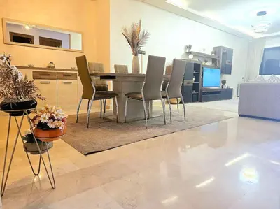 a living room with a dining table and chairs at appartement cosy plein centre in Marrakech