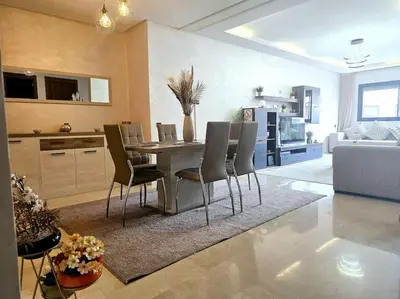 a kitchen and dining room with a table and chairs at appartement cosy plein centre in Marrakech