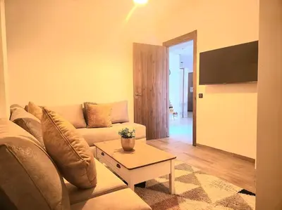 a living room with a couch and a table at appartement cosy plein centre in Marrakech