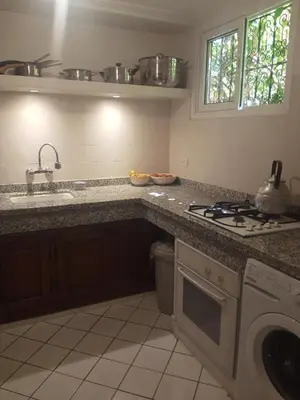 a kitchen with a sink and a stove top oven at Riad Sun and Swim Marrakech in Marrakech