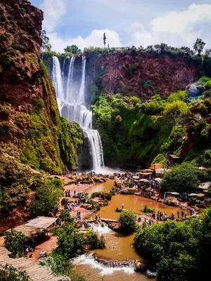 a group of people standing in front of a waterfall at Riad Lwalidin in Marrakech