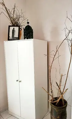 a white cabinet with a potted plant next to it at Riad traditionnel de charme 3 chambres in Marrakech