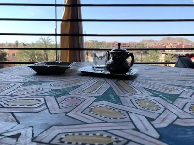 a table with a teapot and a cup on top of it at Séjour lumineux confort et design in Marrakech