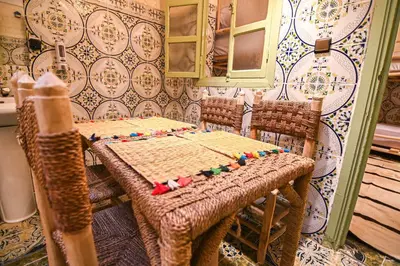 a dining room with a table and two chairs at Oasis Medina Hostel in Marrakech