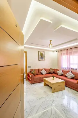 a living room with a couch and a table at Vittoria Guest House Marrakech in Marrakech