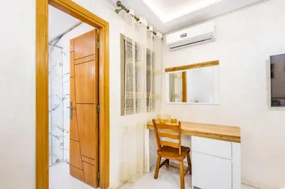 a home office with a wooden desk and a wooden door at Vittoria Guest House Marrakech in Marrakech