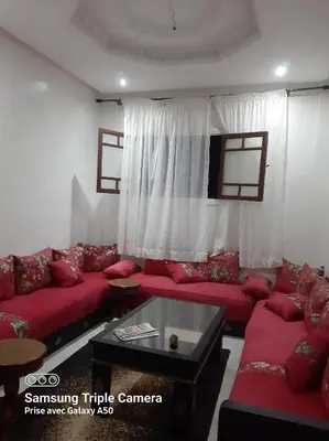 a living room with red couches and a table at إقامة علياء in Marrakech