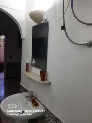 a bathroom with a sink and a mirror on the wall at إقامة علياء in Marrakech