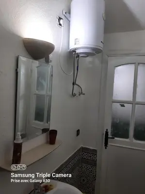 a bathroom with a sink and a mirror at إقامة علياء in Marrakech