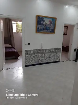 a living room with a painting on the wall at إقامة علياء in Marrakech