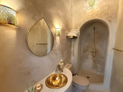 a bathroom with a gold sink and a toilet at Riad privé Sadaka Bassin Rooftop in Marrakech