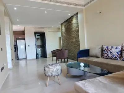 a living room with a couch and a table at résidence assafa central H26 in Marrakech