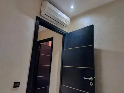 a bathroom with a door and a air conditioner at résidence assafa central H26 in Marrakech