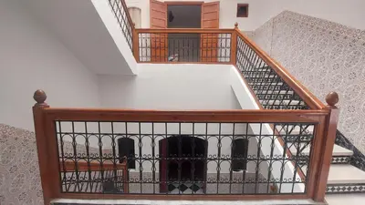 a wooden stair case with a wine bottle in it at Agréable maison familiale in Marrakech