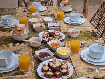 a table with plates of food and glasses of orange juice at Riad Casa Dolce Marrakech Médina in Marrakech