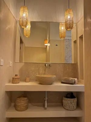a bathroom with a sink and a mirror and baskets at Riad Casa Dolce Marrakech Médina in Marrakech