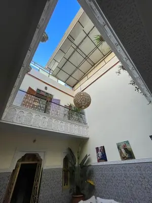 a room with a balcony and a potted plant at Riad Fridi in Marrakech