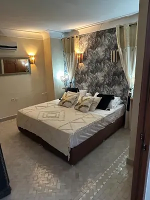 a large bed in a bedroom with a wall at Riad Amazing Amazigh avec jacuzzi petit déjeuner compris avec aussi chambres familiales près de la place jemaa El fna in Marrakech