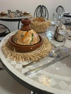 a table with a vase on top of a table at Riad Amazing Amazigh avec jacuzzi petit déjeuner compris avec aussi chambres familiales près de la place jemaa El fna in Marrakech