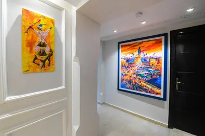 a hallway with a painting on the wall at E-Appartement de luxe centre Gueliz piscine parking fibre netflix in Marrakech