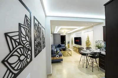 a living room with a table and a dining room at E-Appartement de luxe centre Gueliz piscine parking fibre netflix in Marrakech