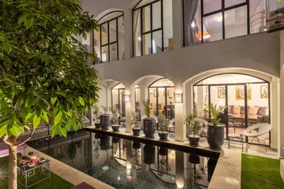 an indoor pool in a building with potted plants at Riad Sybil Boutique Hotel in Marrakech
