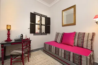 a room with a bed and a desk and a chair at Riad Sybil Boutique Hotel in Marrakech