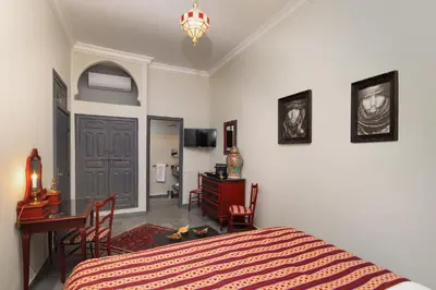 a bedroom with a bed and a desk and a table at Riad Sybil Boutique Hotel in Marrakech