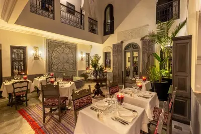 a dining room with white tables and chairs at Riad Sybil Boutique Hotel in Marrakech
