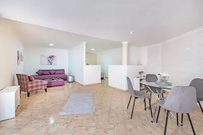 a living room with a purple couch and a table at Cosy apartment in the heart of Hivernage in Marrakech