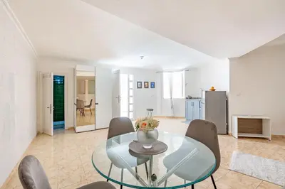a dining room with a glass table and chairs at Cosy apartment in the heart of Hivernage in Marrakech