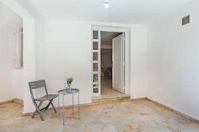 a room with a table and a chair and a hallway at Cosy apartment in the heart of Hivernage in Marrakech