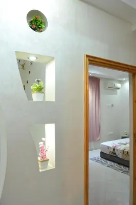a room with a mirror and some plants on a wall at Riad Bollywood- family charm in Benguerir