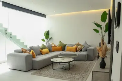 a living room with a couch and a table at Duplex piscine chauffée terrasse in Marrakech