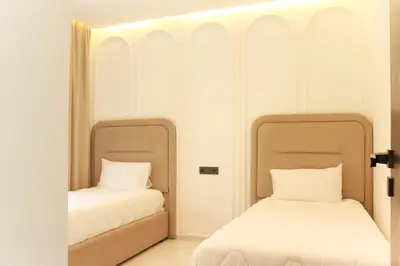 two beds sitting next to each other in a room at Duplex piscine chauffée terrasse in Marrakech