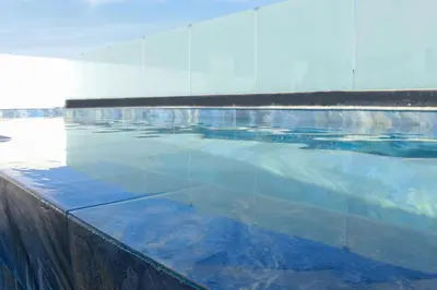 a large swimming pool with blue water at Duplex piscine chauffée terrasse in Marrakech