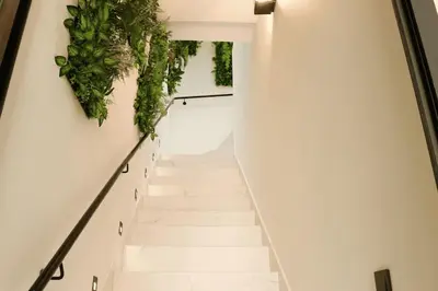 a staircase with plants on the wall at Duplex piscine chauffée terrasse in Marrakech