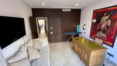 a living room with a couch and a table at Appartement de luxe a Care Eden in Marrakech
