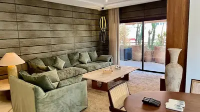 a living room with a couch and a table at Appartement de luxe a Care Eden in Marrakech
