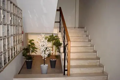 a stairway with potted plants and a staircase with stairs at appartement hivernage marrakech avec piscine in Marrakech