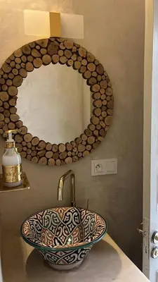 a bathroom with a sink and a mirror at Riad EL BADI in Marrakech