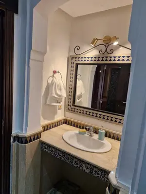 a bathroom with a sink and a mirror at Appartement babylon 2 marrakech in Marrakech